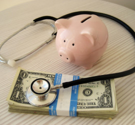 stethescope, piggy bank, and dollar bills