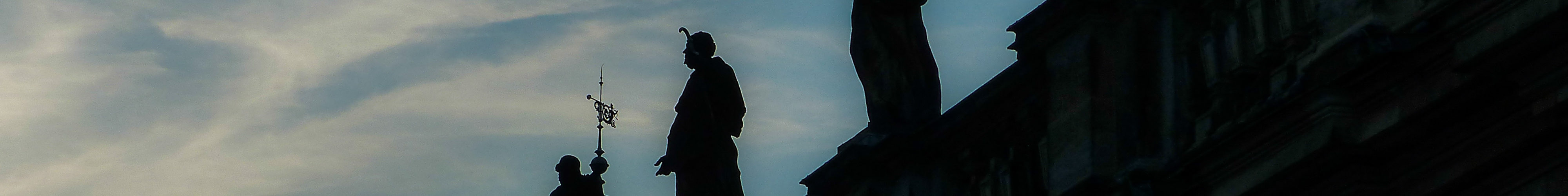 Silhouettes of statues of saints on the Katolische Hofkiche in Dresden, Germany.