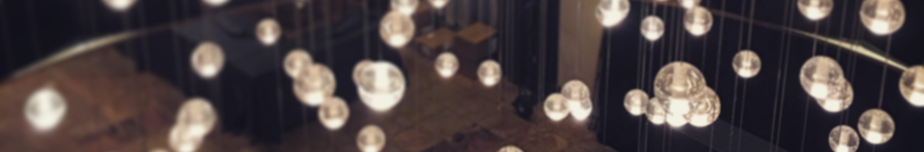 Floating lights over a table covered in a red tablecloth that says "Writer's Digest."